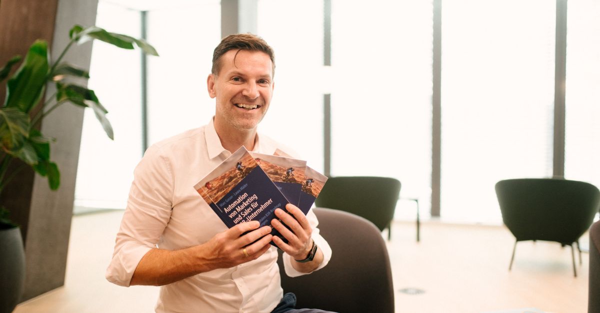 Man holding a book about B2B Marketing Automation